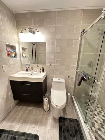 a bathroom with a sink toilet and a mirror