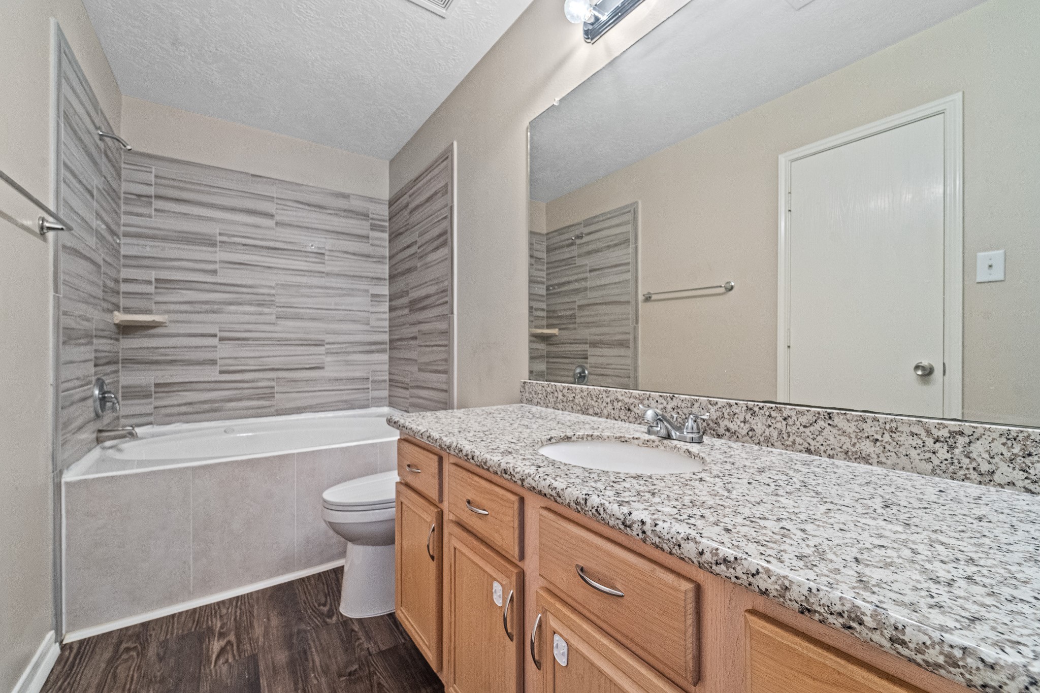 6827 Highwind Bend Lane Katy, TX 77449 - Photo 13 of 20 a bathroom with a granite countertop sink toilet and shower