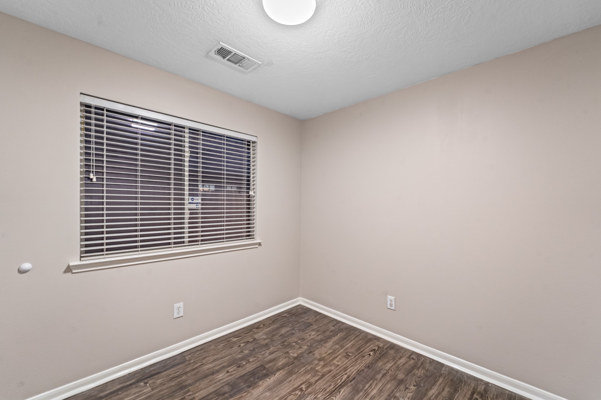 6827 Highwind Bend Lane Katy, TX 77449 - Photo 16 of 20 a view of an empty room with wooden floor and a window