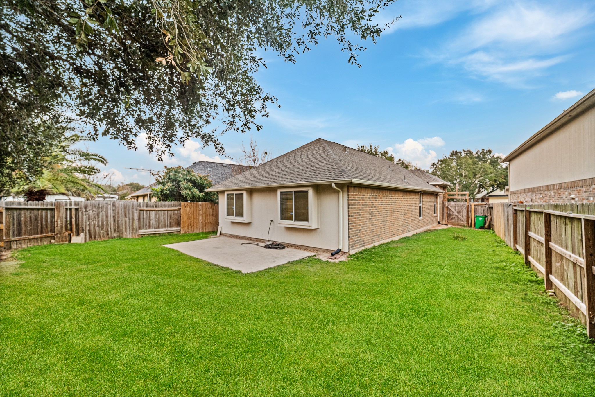 6827 Highwind Bend Lane Katy, TX 77449 - Photo 20 of 20 a yellow and red house with a garden