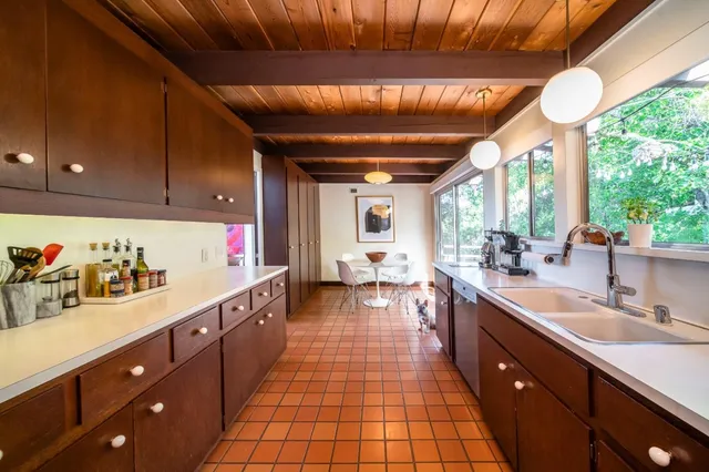 a large kitchen with lots of counter space and windows