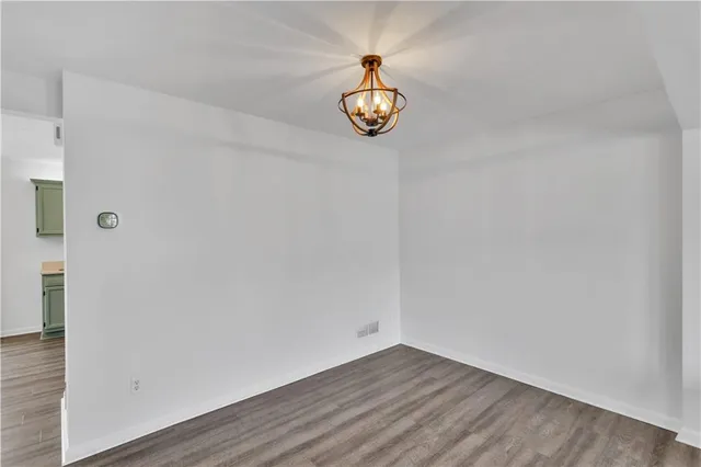a view of room with wooden floor and window