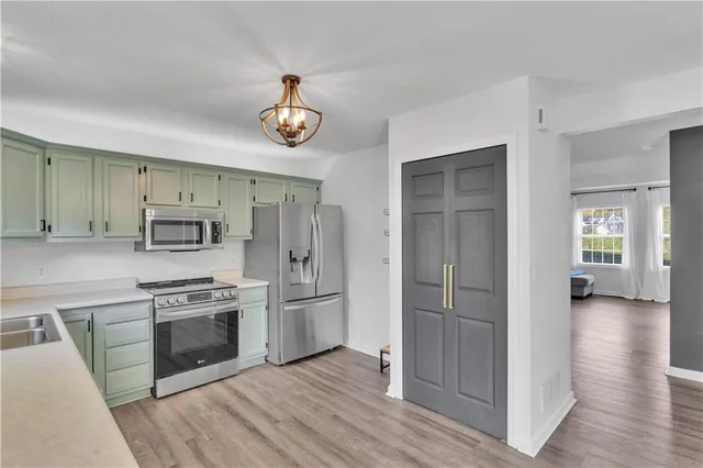 a kitchen with a refrigerator and a stove top oven