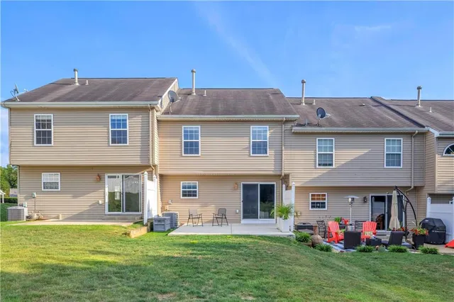 a front view of house with yard and outdoor seating