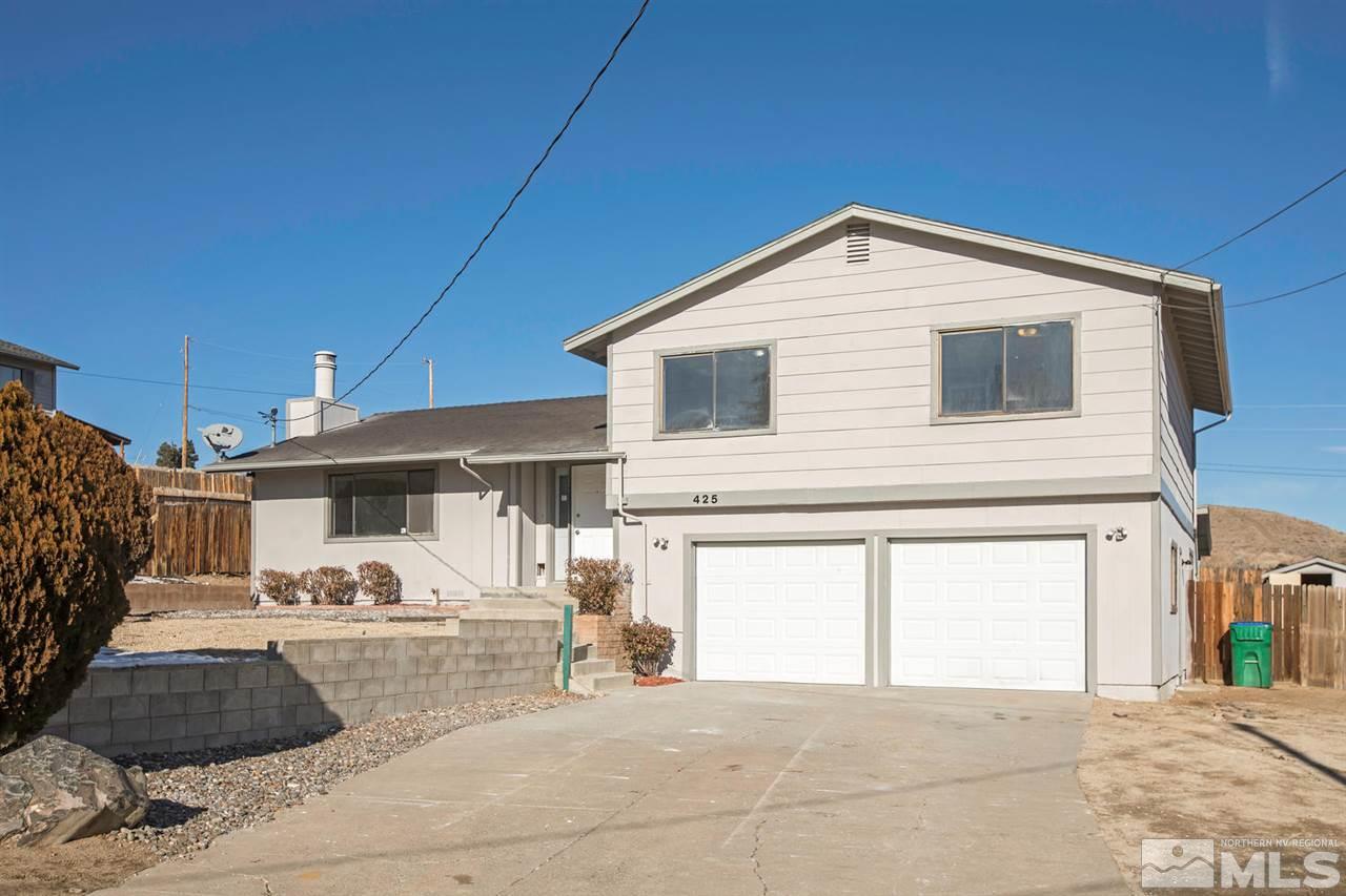 a front view of a house with garage