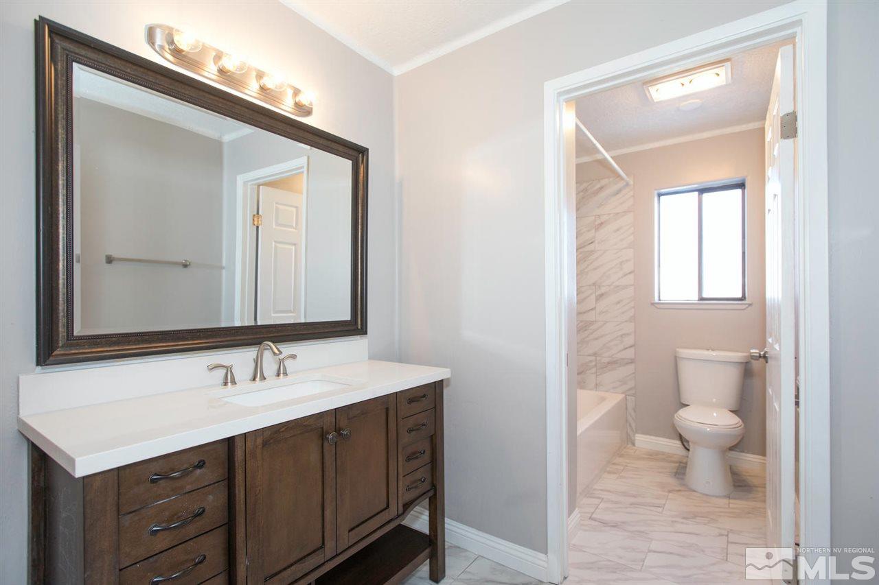 425 Hoge Road Reno, NV 89506 - Photo 15 of 25 a bathroom with a toilet sink and mirror