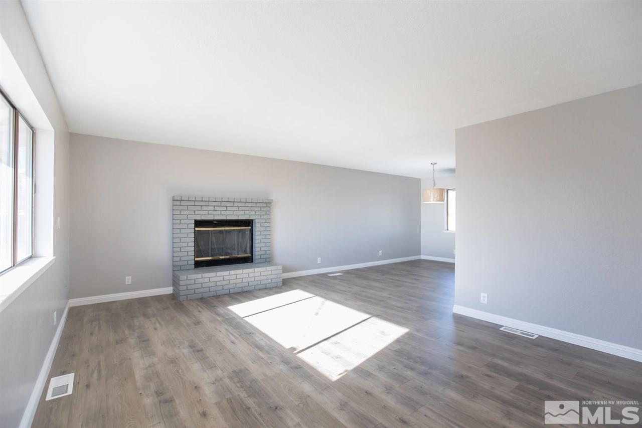 425 Hoge Road Reno, NV 89506 - Photo 4 of 25 an empty room with wooden floor and windows