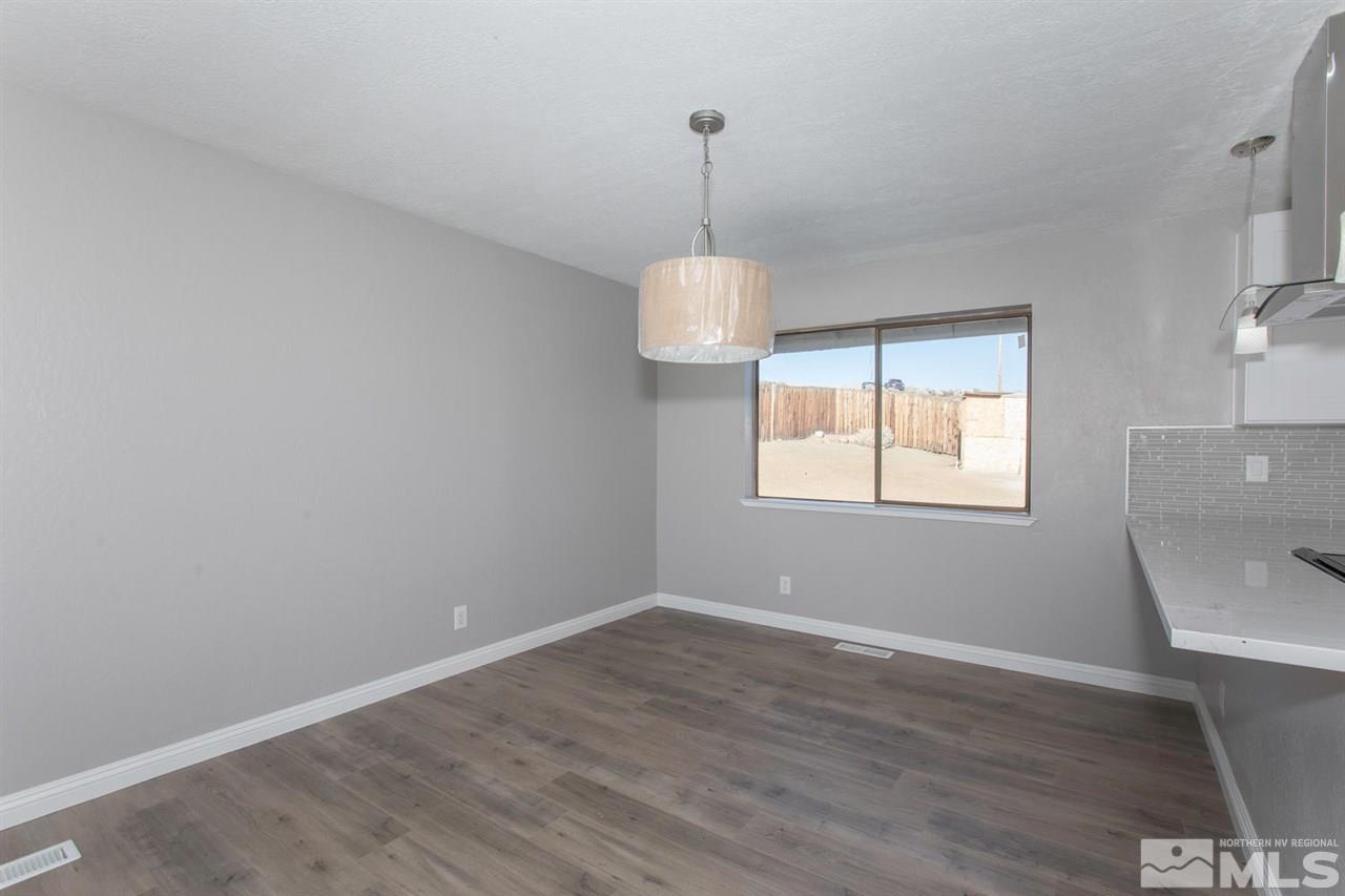 425 Hoge Road Reno, NV 89506 - Photo 5 of 25 a room with wooden floor and windows