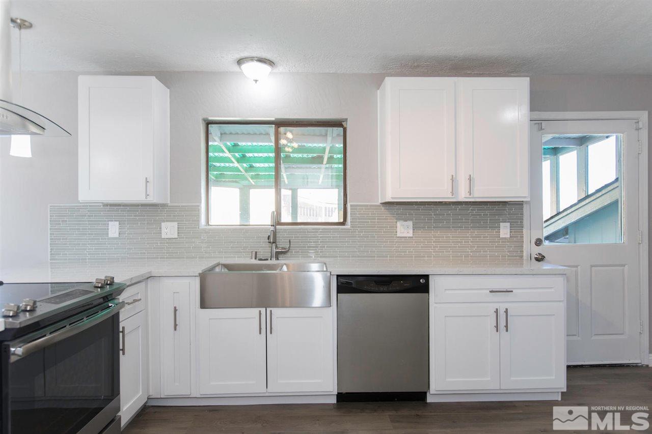 425 Hoge Road Reno, NV 89506 - Photo 7 of 25 a kitchen with white cabinets and white appliances