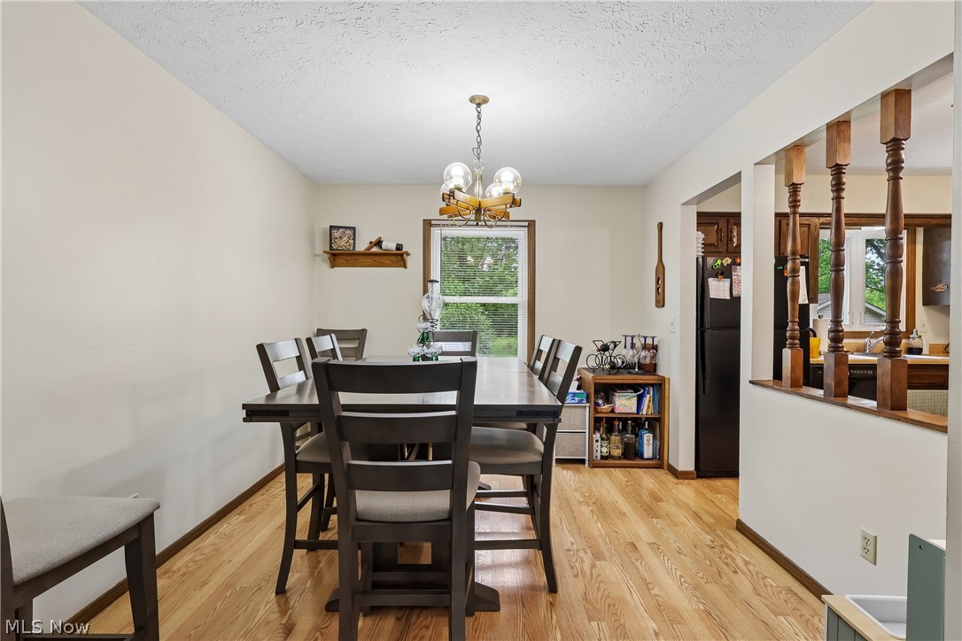 4702 Alger Road Richfield, OH 44286 - Photo 13 of 46 Dining room with chandelier and LVT flooring