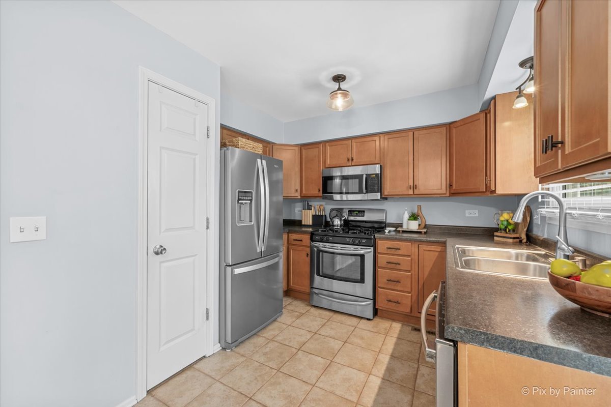 1150 Appleton Lane Geneva, IL 60134 - Photo 19 of 43 a kitchen with stainless steel appliances granite countertop a refrigerator stove top oven and sink