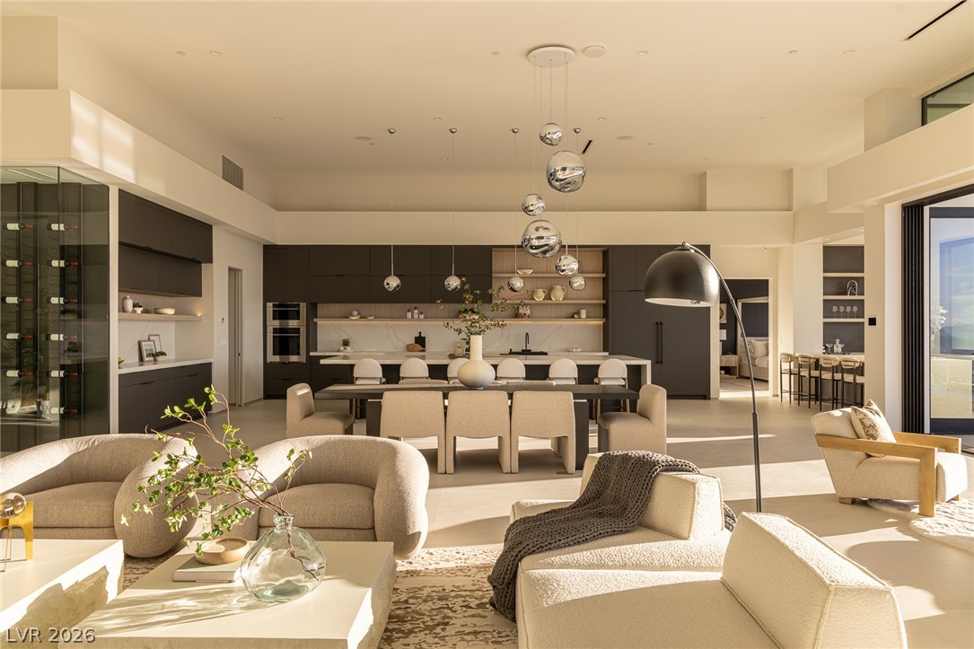 563 Grand Rim Drive Henderson, NV 89012 - Photo 6 of 70 An open-concept living space with clean lines connects a sleek kitchen and a dedicated dining area.