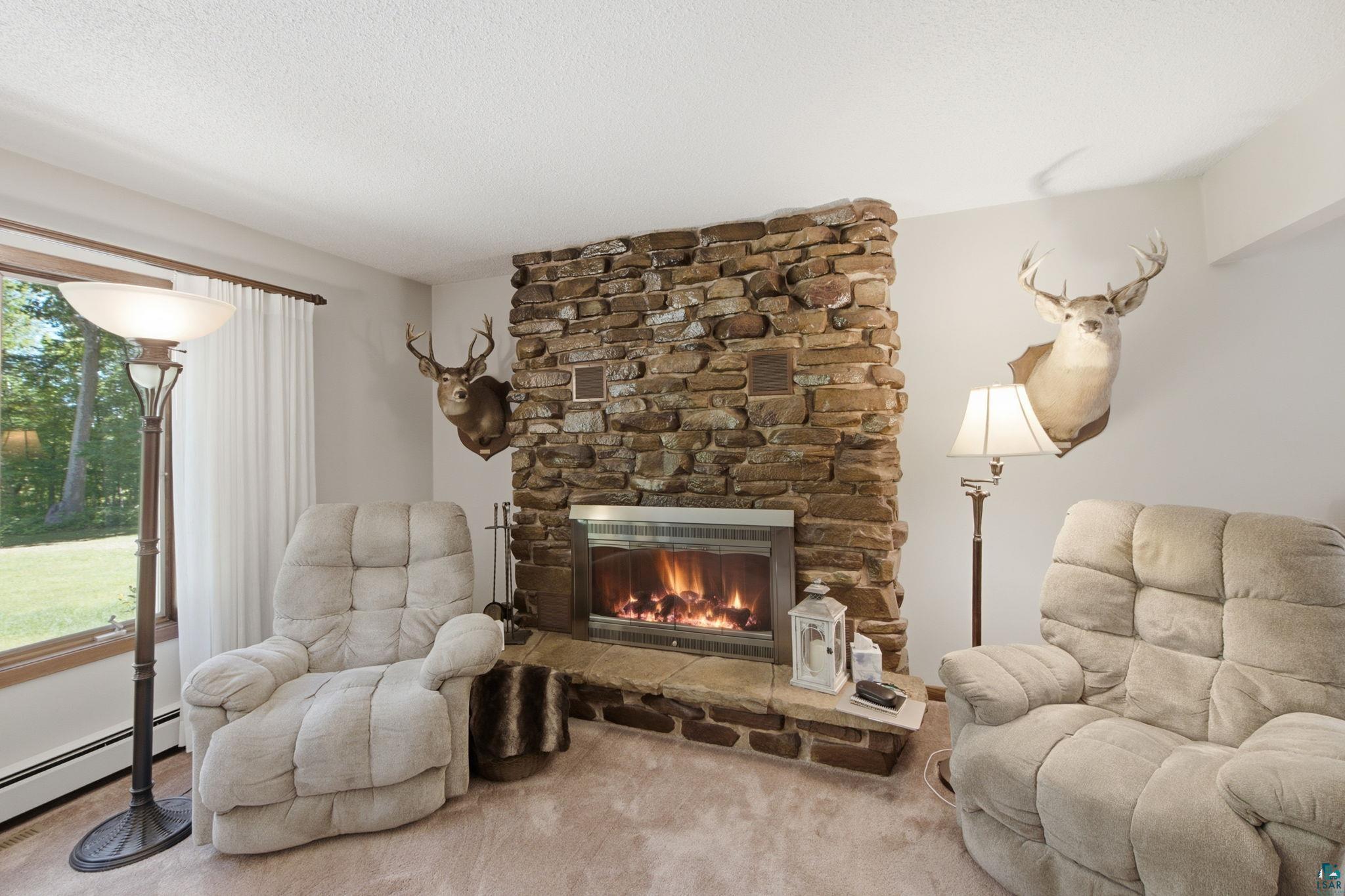 27485 South Kane Road Ashland, WI 54806 - Photo 3 of 35 Stone-clad fireplace with a raised hearth and a glass-front insert
