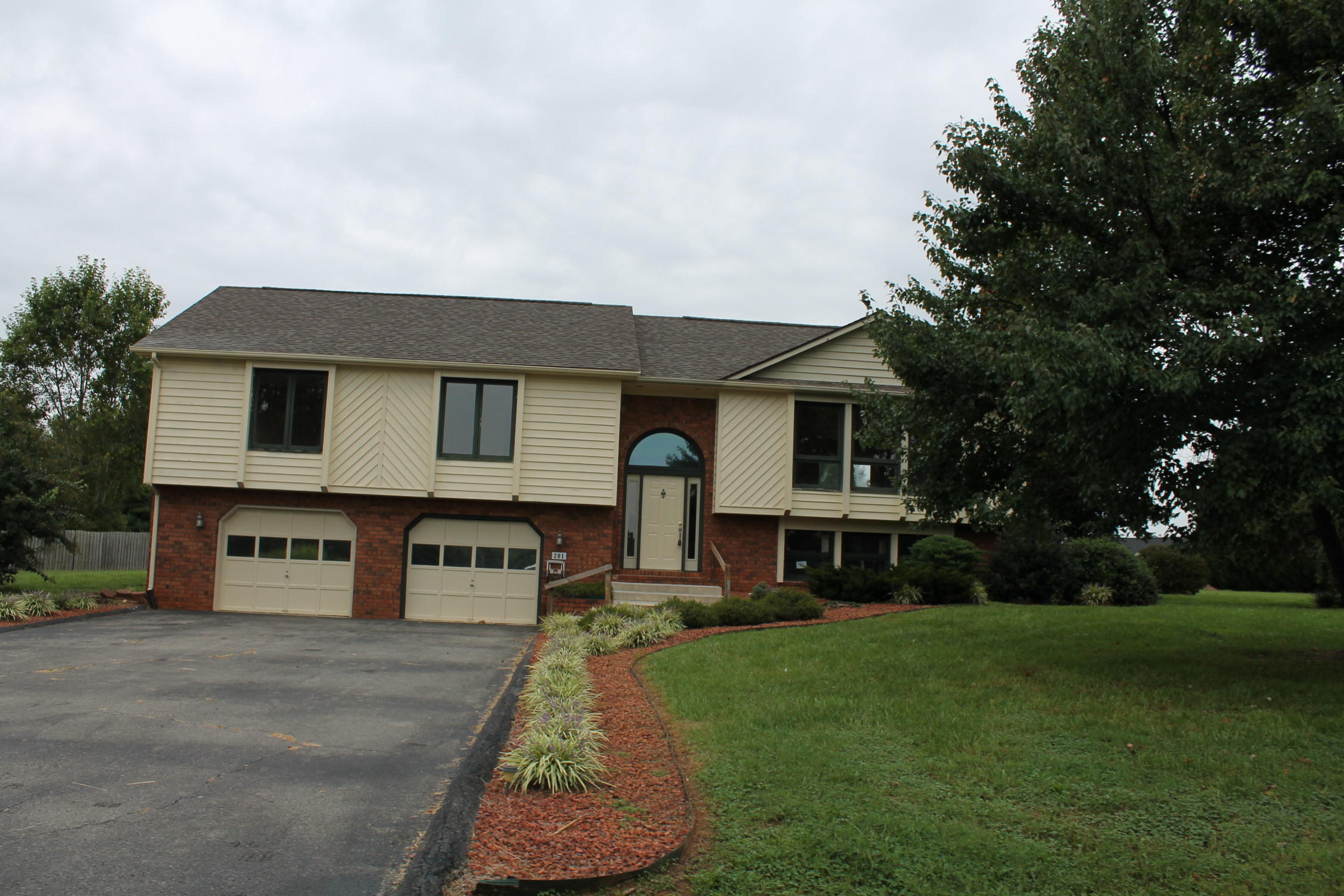 201 Aftons Meadow Road Vinton, VA 24179 - Photo 1 of 18 a front view of a house with a yard table and chairs