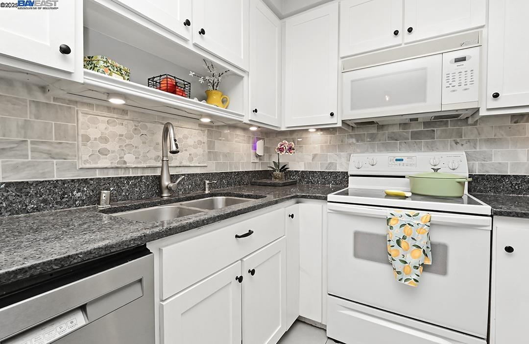 1031 Spring Valley Common Livermore, CA 94551 - Photo 13 of 26 a kitchen with stainless steel appliances granite countertop a sink and a stove