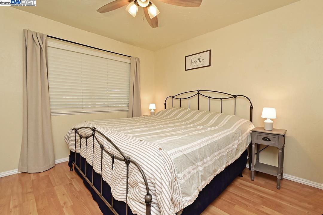 1031 Spring Valley Common Livermore, CA 94551 - Photo 16 of 26 a bedroom with a bed and a chandelier