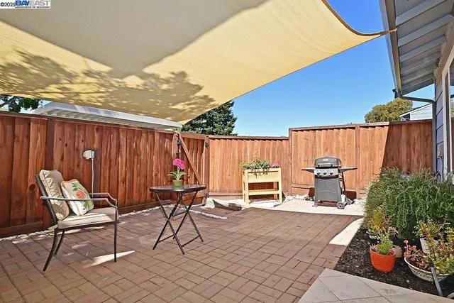 a patio with table and chairs