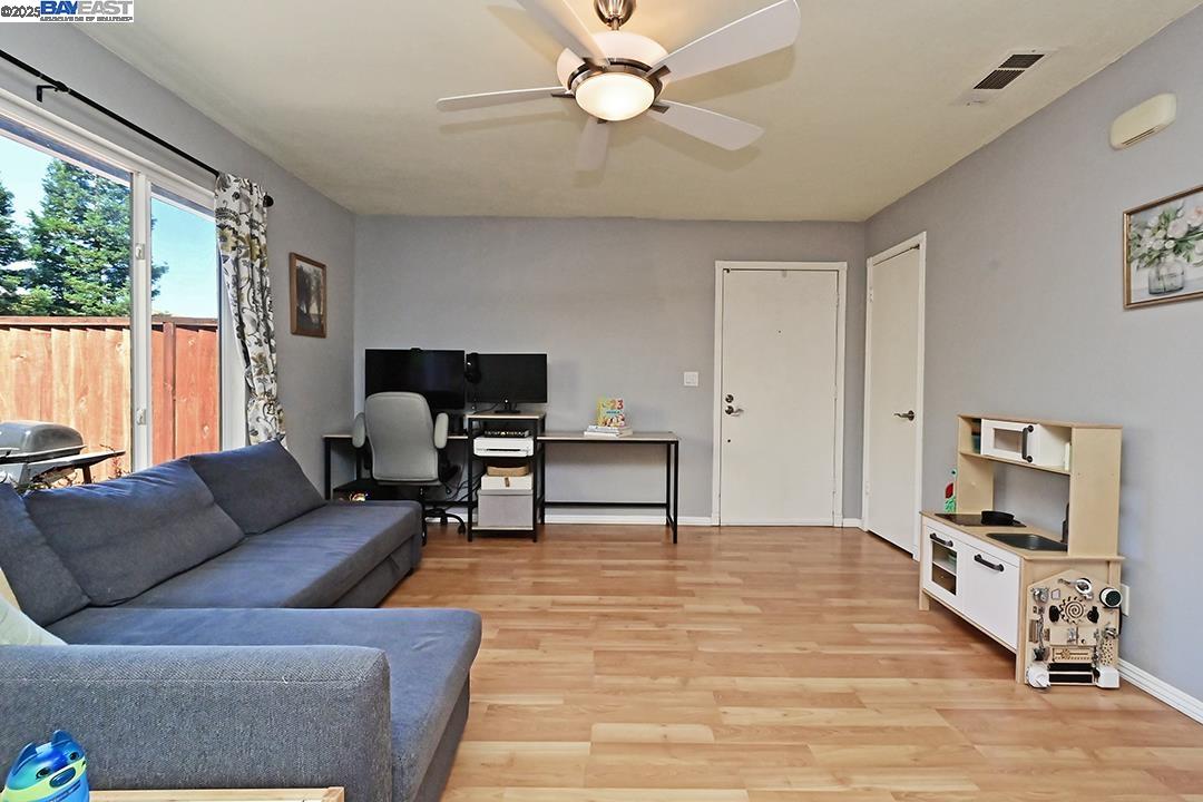 1031 Spring Valley Common Livermore, CA 94551 - Photo 8 of 26 a living room with furniture and a flat screen tv