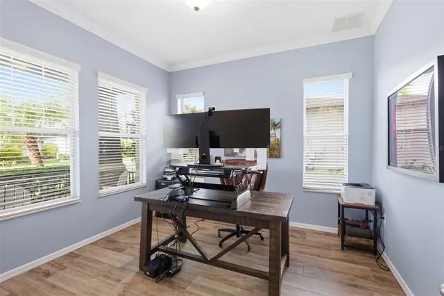 a large white kitchen with a large window and stainless steel appliances