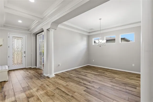 a view of a dining room with furniture and wooden floor
