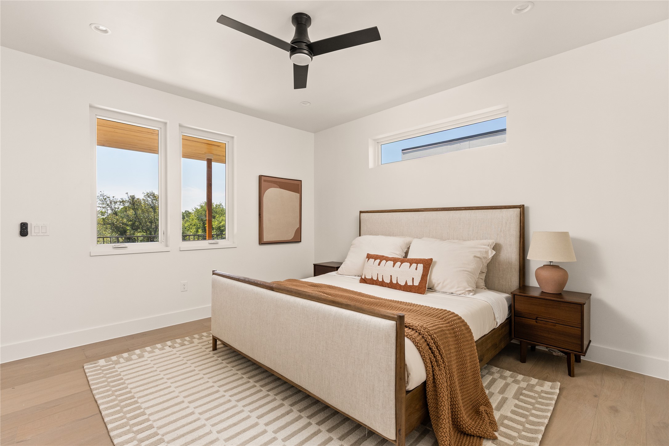 4530 Clawson Road, Unit 1 Austin, TX 78745 - Photo 19 of 24 Bedroom featuring multiple windows, a ceiling fan, and light wood finished floors