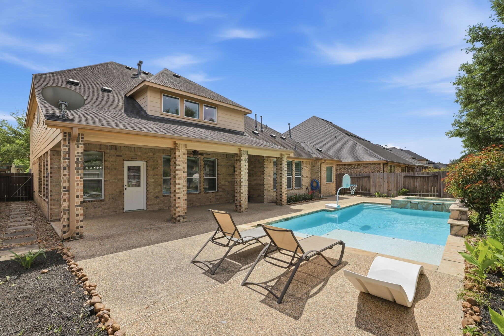 8169 Tranquil Lake Way Conroe, TX 77385 - Photo 18 of 26 a view of a house with backyard sitting area and garden