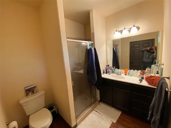 a bathroom with a sink and mirror with toilet