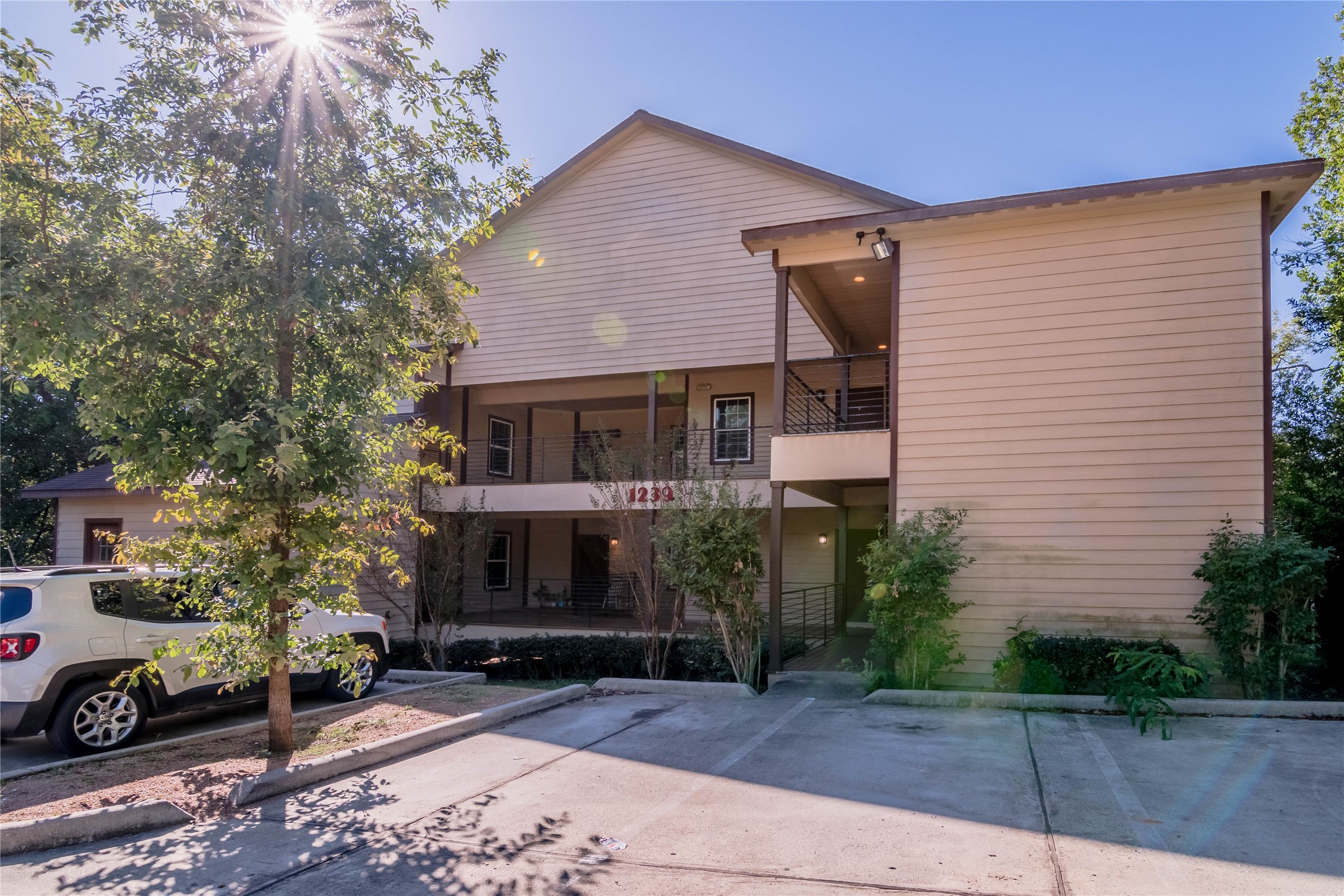 1239 20th Street, Unit B Huntsville, TX 77340 - Photo 2 of 17 a front view of a house with a yard
