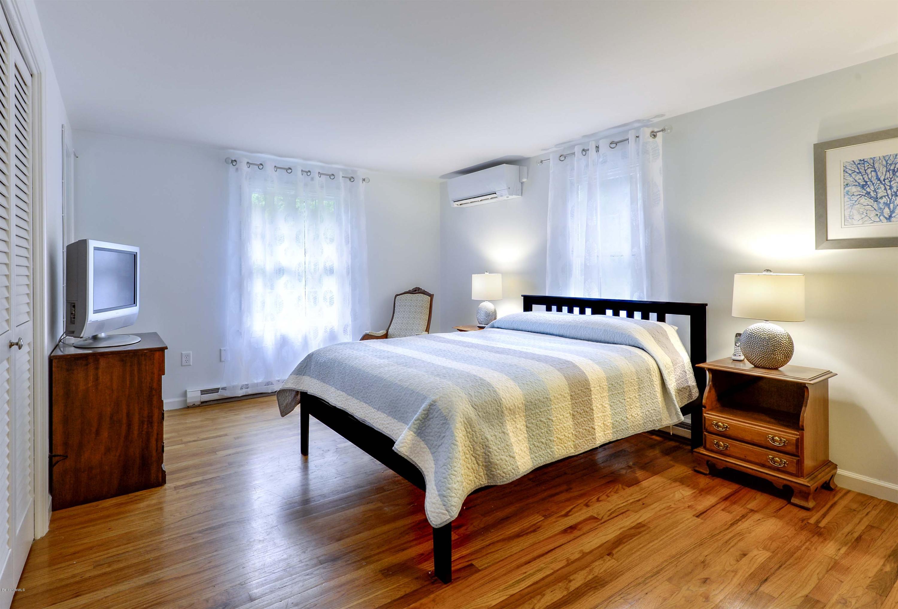 350 Lenox Road Richmond, MA 01254 - Photo 18 of 30 a spacious bedroom with a bed and wooden floor