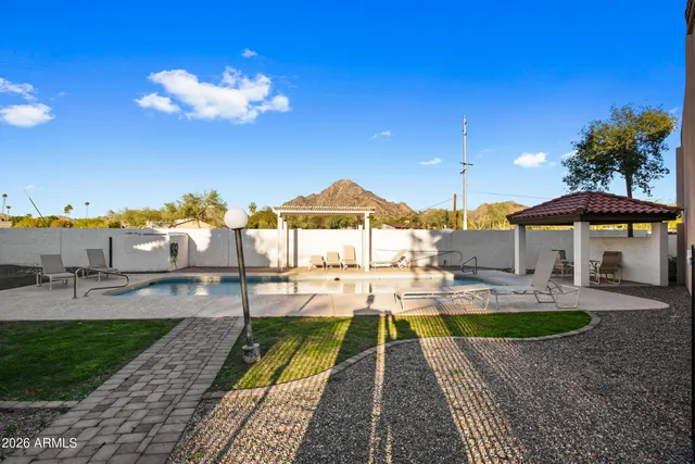 a view of a house with patio swimming pool and a yard