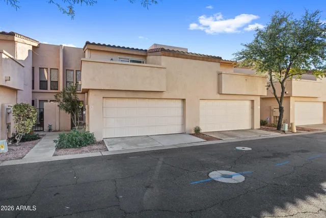a view of a parking space in front of a house