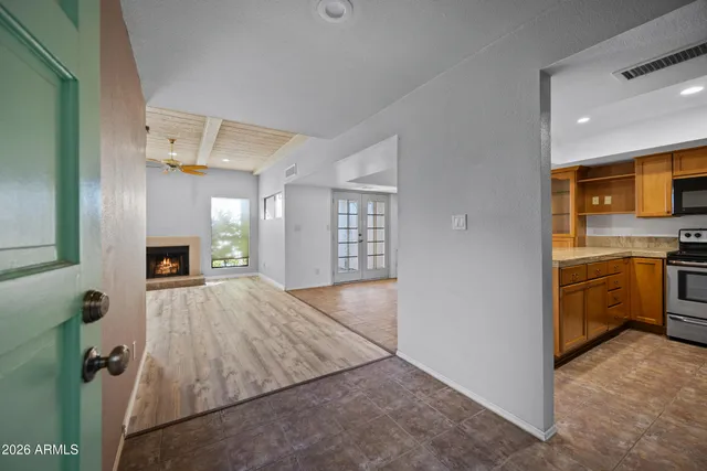 a view of a kitchen and a windows an empty room