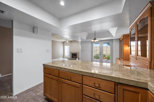 a bathroom with a granite countertop sink and a large mirror
