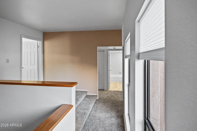 a view of hallway with furniture and a window