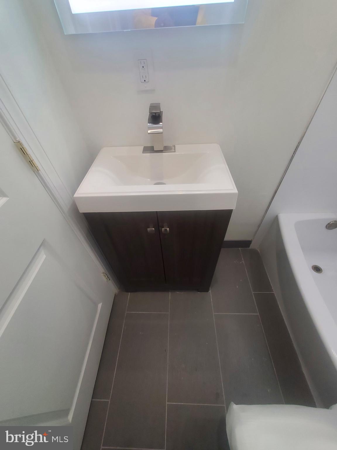 1122 Penn Street Northeast, Unit 1 Washington, DC 20002 - Photo 16 of 31 a bathroom with a sink and mirror