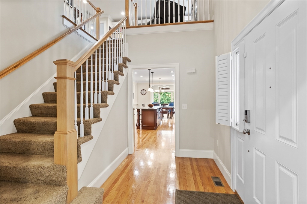 57 Sunset Ridge Lane, Unit 57 Bolton, MA 01740 - Photo 18 of 42 a view of a hallway with wooden floor and staircase