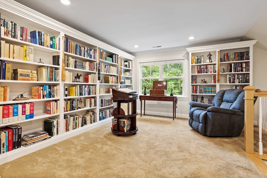 57 Sunset Ridge Lane, Unit 57 Bolton, MA 01740 - Photo 20 of 42 a living room with furniture and a book shelf