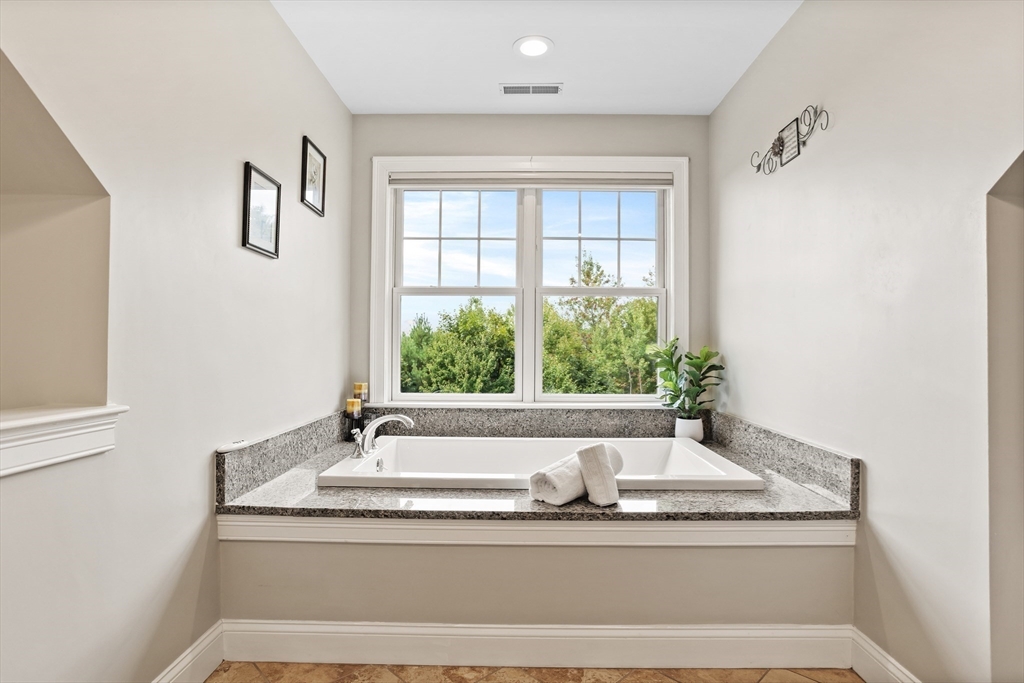 57 Sunset Ridge Lane, Unit 57 Bolton, MA 01740 - Photo 25 of 42 a bathroom with a granite countertop sink and a window