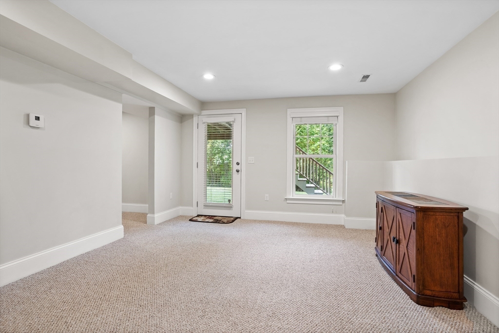 57 Sunset Ridge Lane, Unit 57 Bolton, MA 01740 - Photo 32 of 42 a view of an empty room with a window