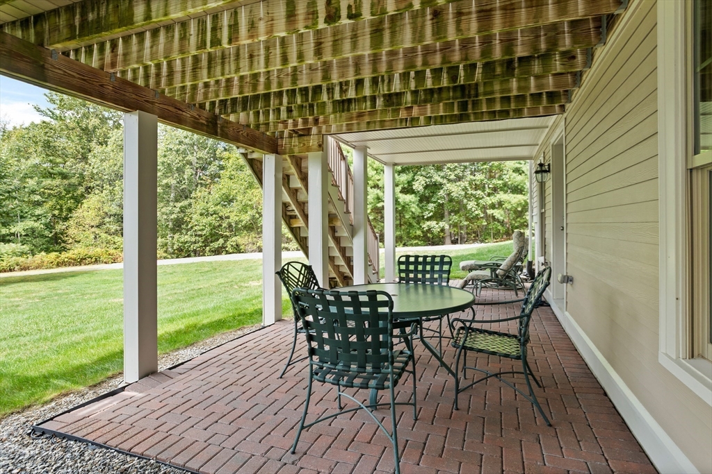 57 Sunset Ridge Lane, Unit 57 Bolton, MA 01740 - Photo 33 of 42 a view of a chairs and table in the balcony