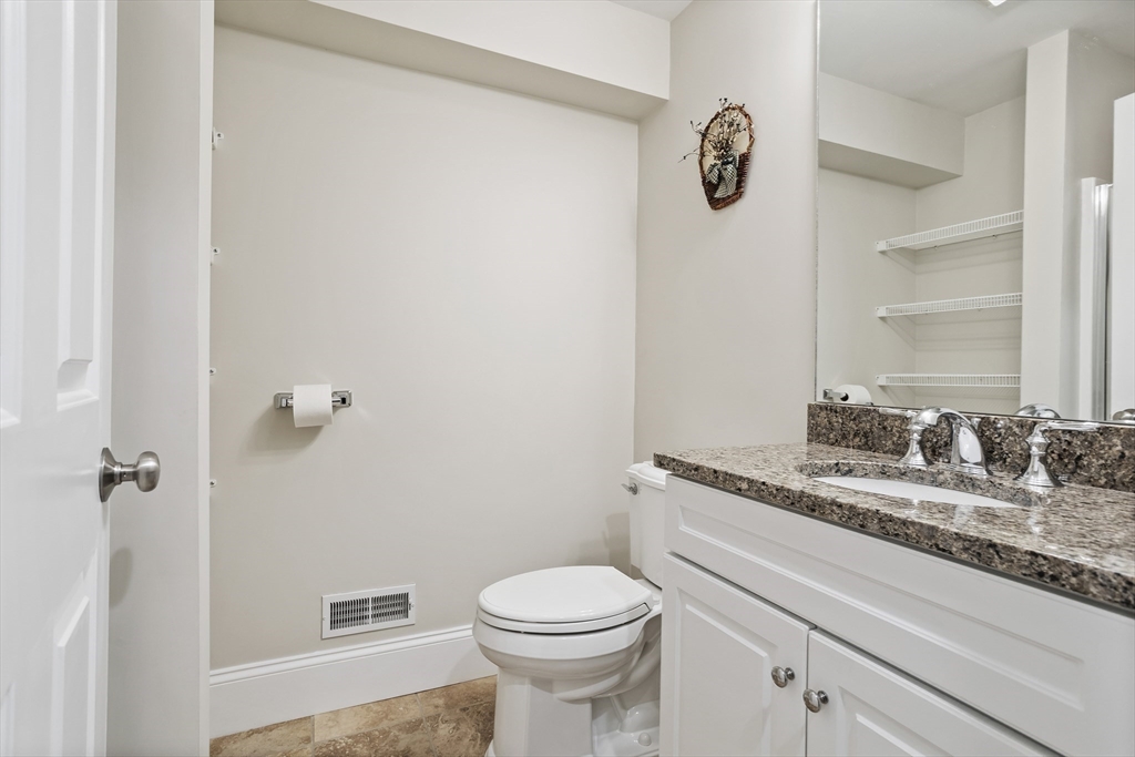 57 Sunset Ridge Lane, Unit 57 Bolton, MA 01740 - Photo 34 of 42 a bathroom with a granite countertop toilet and a sink