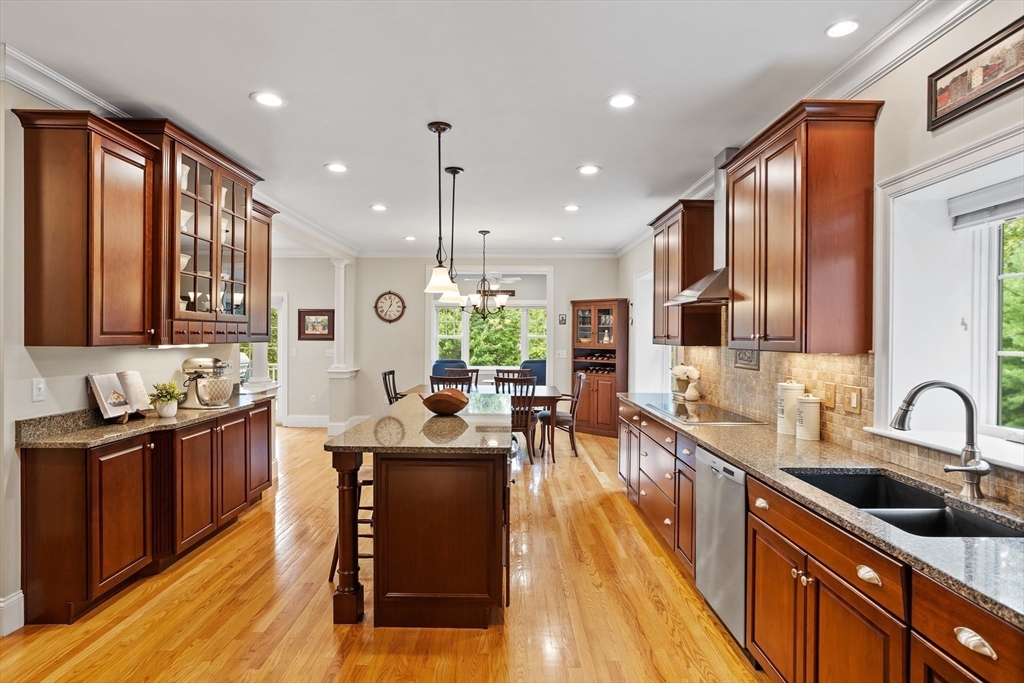 57 Sunset Ridge Lane, Unit 57 Bolton, MA 01740 - Photo 6 of 42 a kitchen with stainless steel appliances granite countertop sink stove refrigerator and cabinets