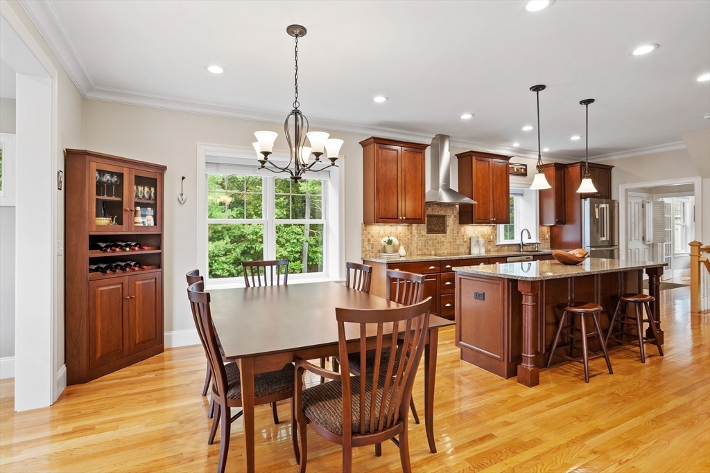 57 Sunset Ridge Lane, Unit 57 Bolton, MA 01740 - Photo 7 of 42 a view of a dining room and livingroom with furniture wooden floor a chandelier