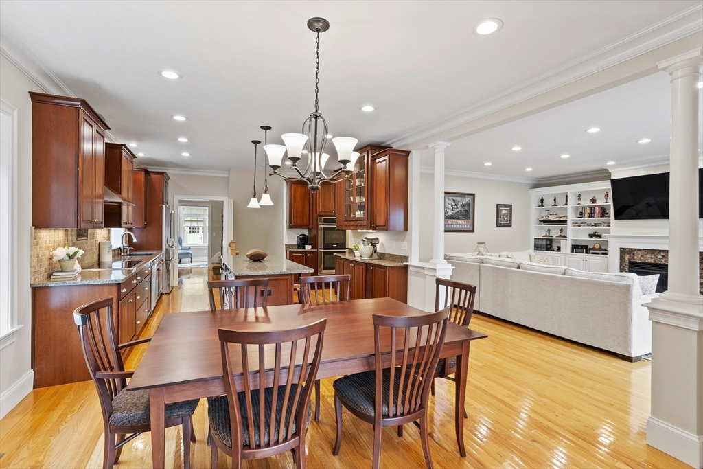 57 Sunset Ridge Lane, Unit 57 Bolton, MA 01740 - Photo 10 of 42 a view of a dining room and livingroom with furniture a chandelier and kitchen view