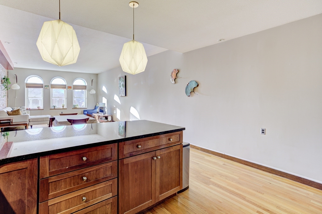 231 Main Street, Unit 3R Northampton, MA 01060 - Photo 11 of 23 a view of a hallway with wooden floor and chandelier