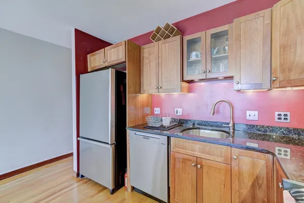 a kitchen with stainless steel appliances granite countertop a refrigerator and a sink