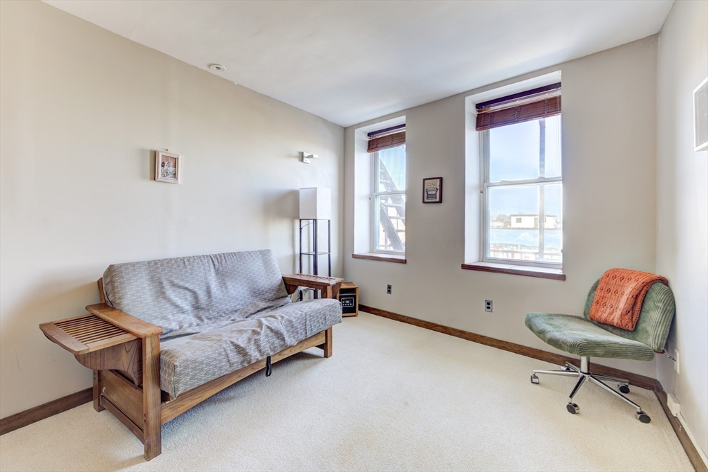 231 Main Street, Unit 3R Northampton, MA 01060 - Photo 13 of 22 a living room with furniture and a window