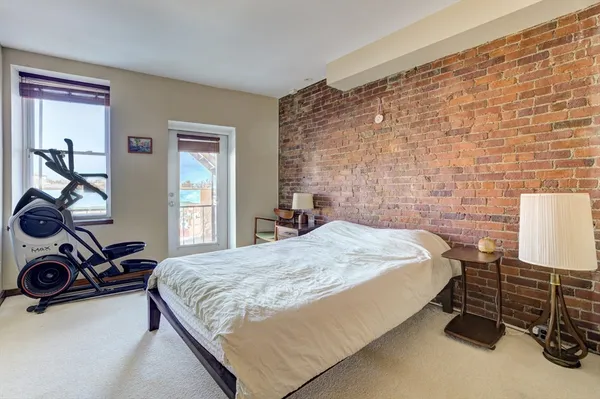 a bedroom with a bed and a desk