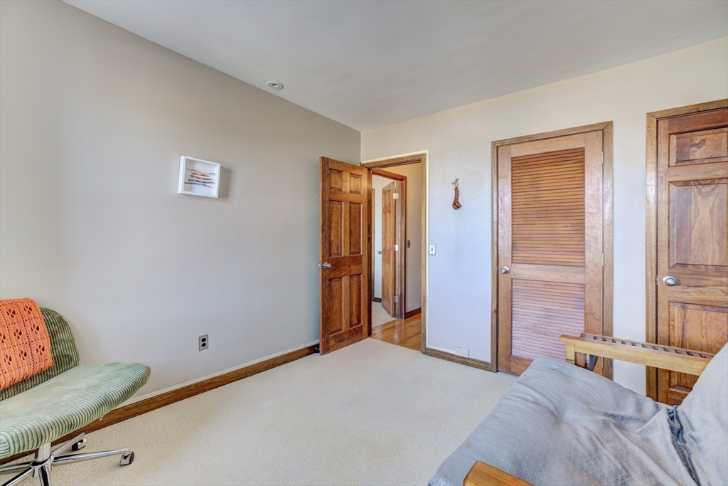 231 Main Street, Unit 3R Northampton, MA 01060 - Photo 14 of 22 a bedroom with a bed and a table