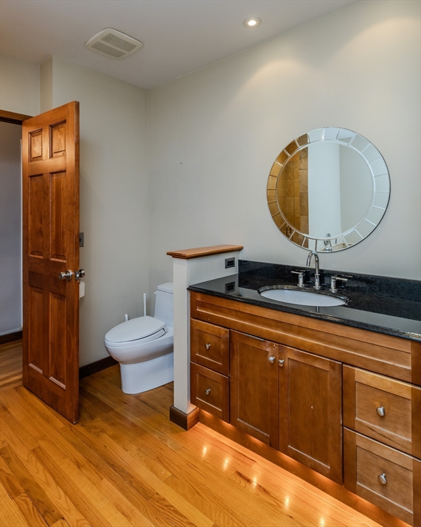 231 Main Street, Unit 3R Northampton, MA 01060 - Photo 16 of 22 a bathroom with a sink a toilet and mirror